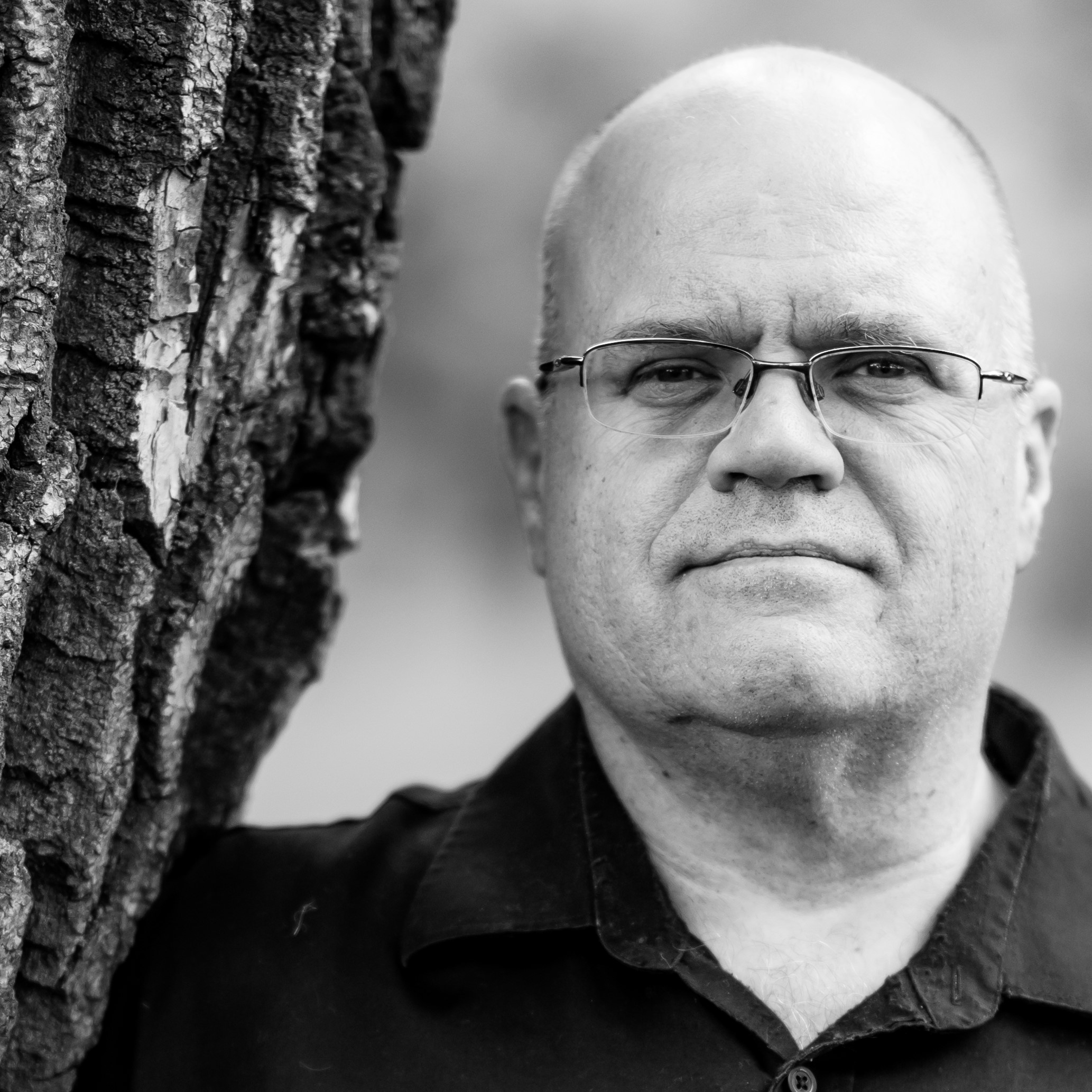 head shot of George Read standing beside a tree